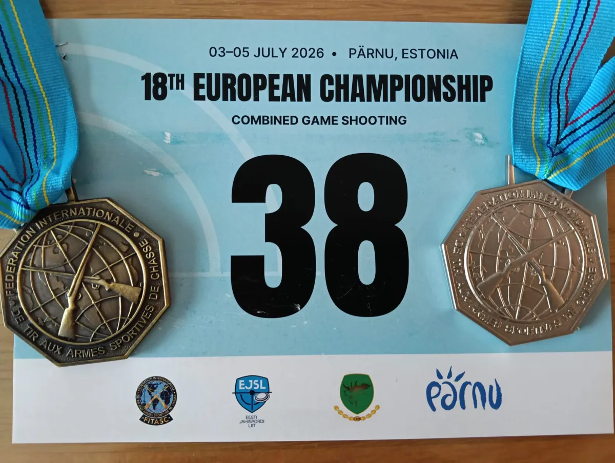 Startnummer 38 der 18. Europameisterschaft im kombinierten jagdlichen Schießen vom 3. bis 5. Juli 2026 in Pärnu, Estland, links und rechts daneben je eine Medaille am hellblauen Band